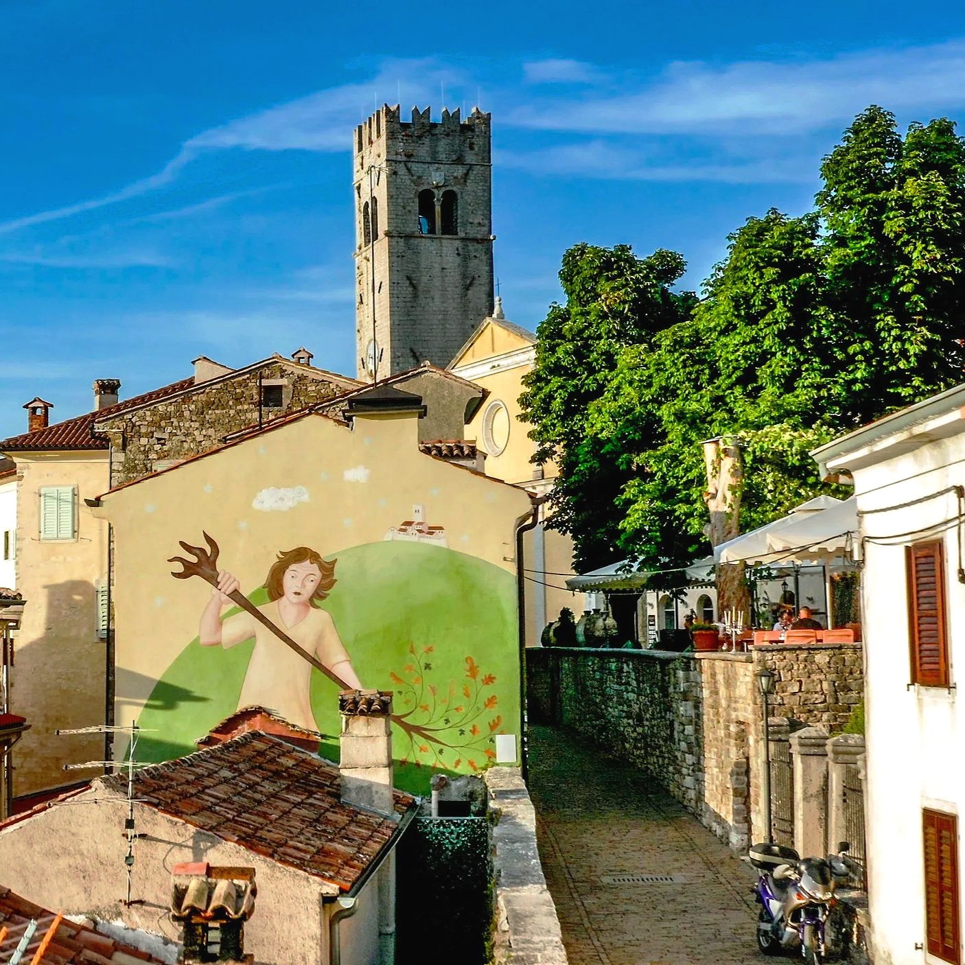 Motovun, Istria, Croatia, featuring cobblestone streets, historic stone architecture, and a mural of the legendary local giant Veli Jože.