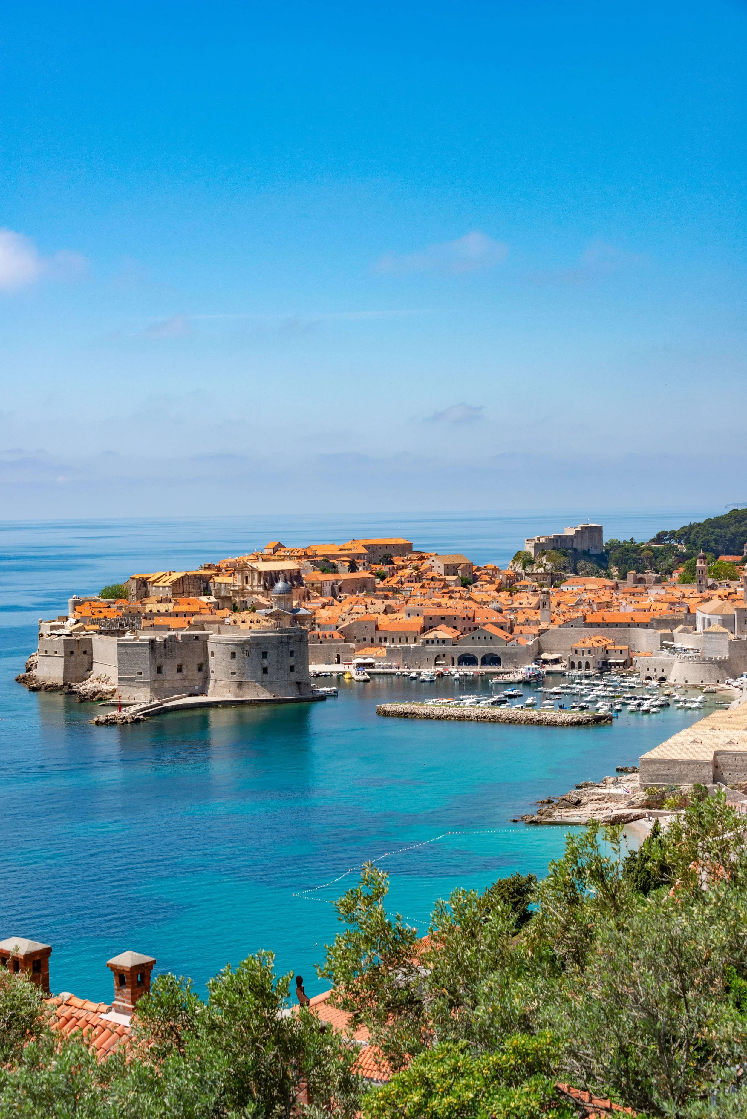 Dubrovnik, Croatia, featuring historic architecture and terracotta rooftops along the sparkling Adriatic Sea.
