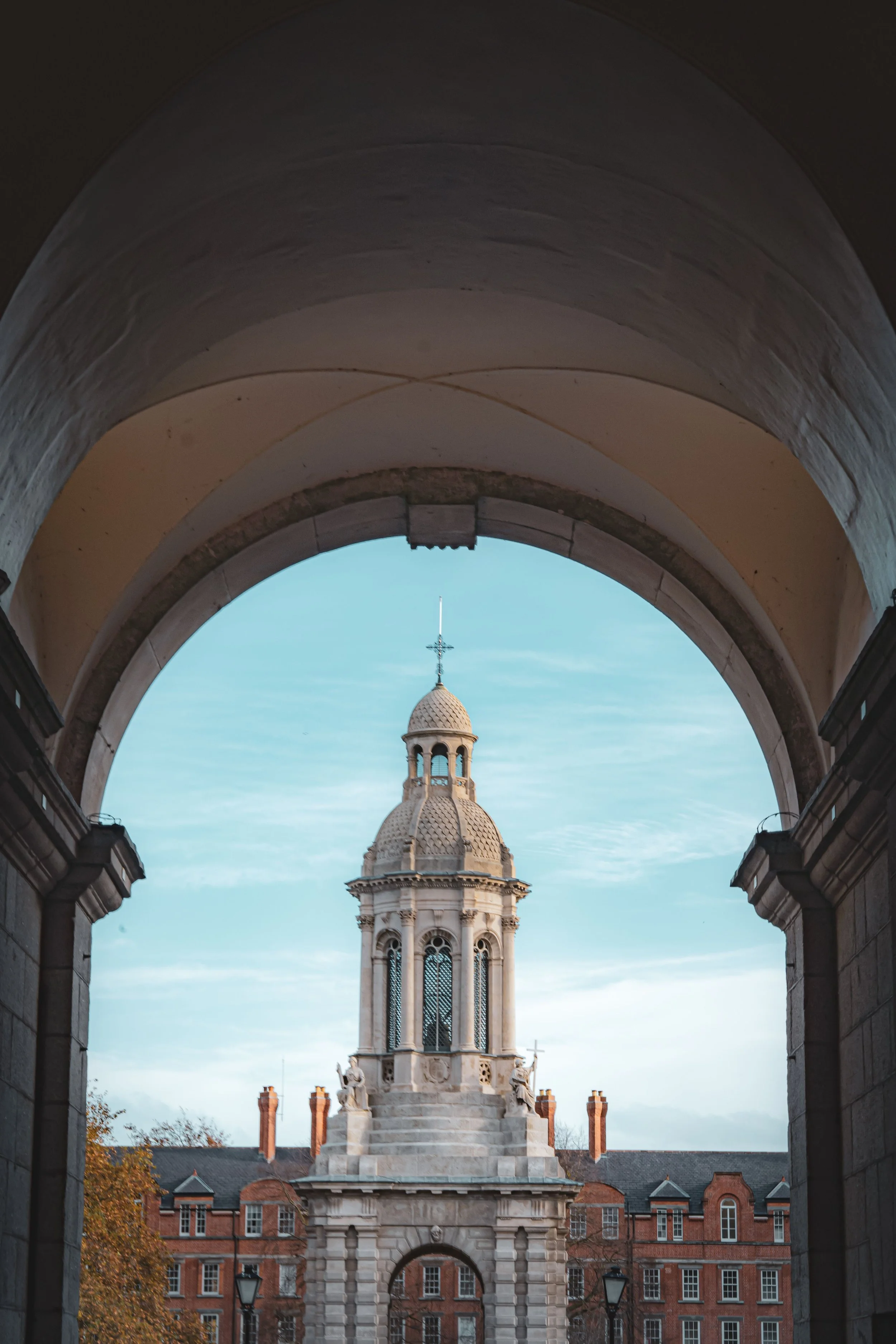 Trinity College Campanile in Dublin, Ireland, a historic landmark framed by an elegant archway at the heart of the university campus.