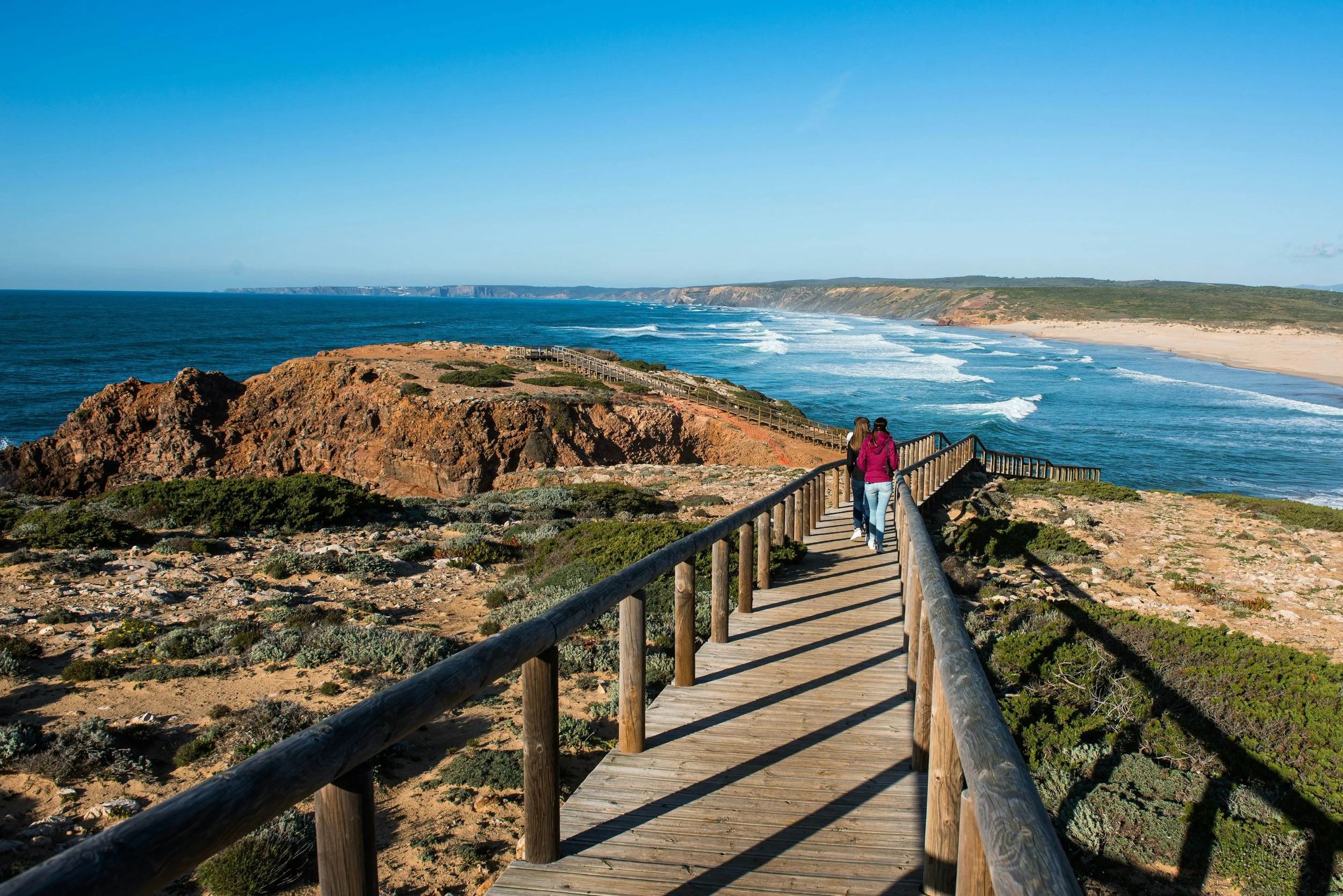 Bordeira Beach, with coastal cliffs and a wooden boardwalk near Carrapateira, Algarve, Portugal.