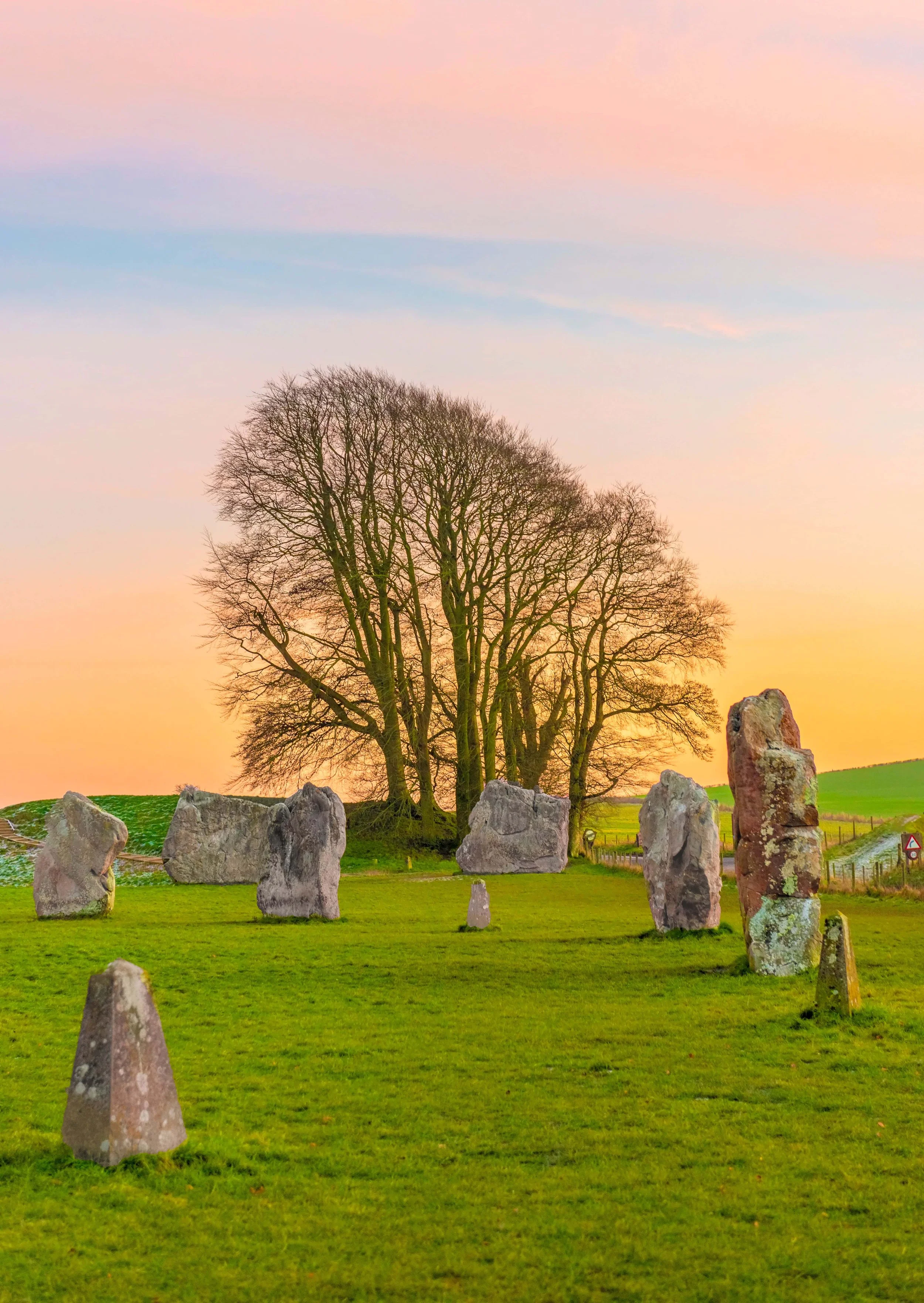Standing stones of the Avebury circle with the village and fields beyond, Wiltshire, England