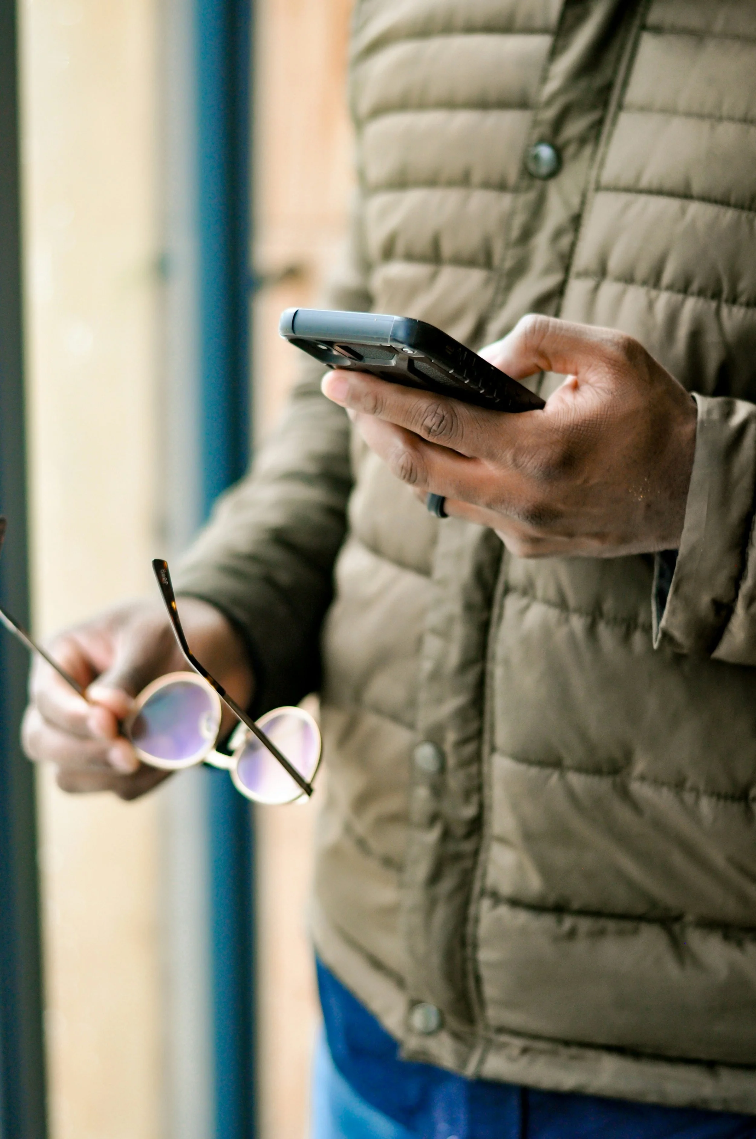 Photo of man dialing a number on his smart phone
