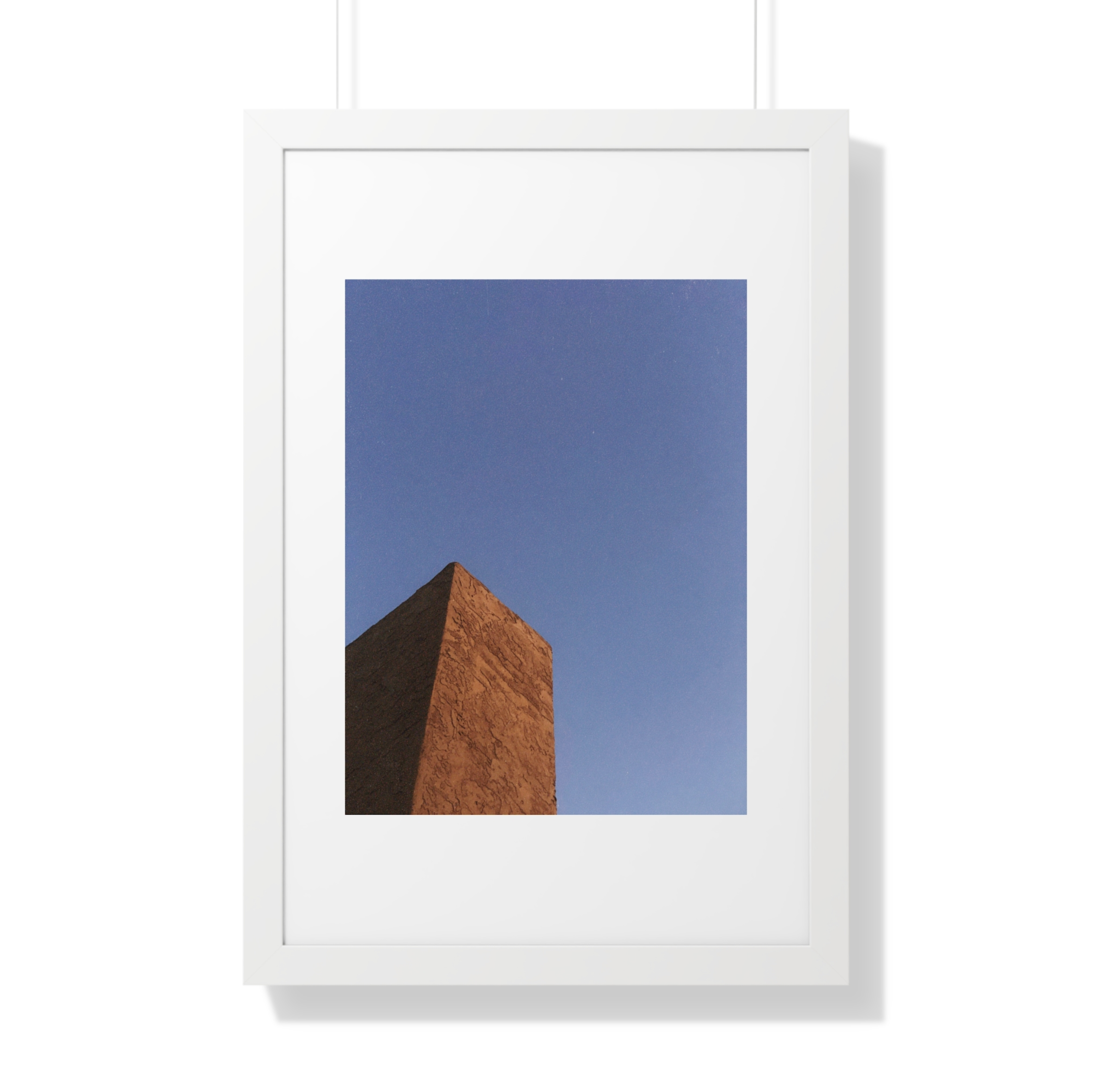 Clay colored chimney against blue sky