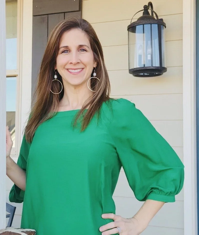 abbie smith wearing green blouse smiling warmly