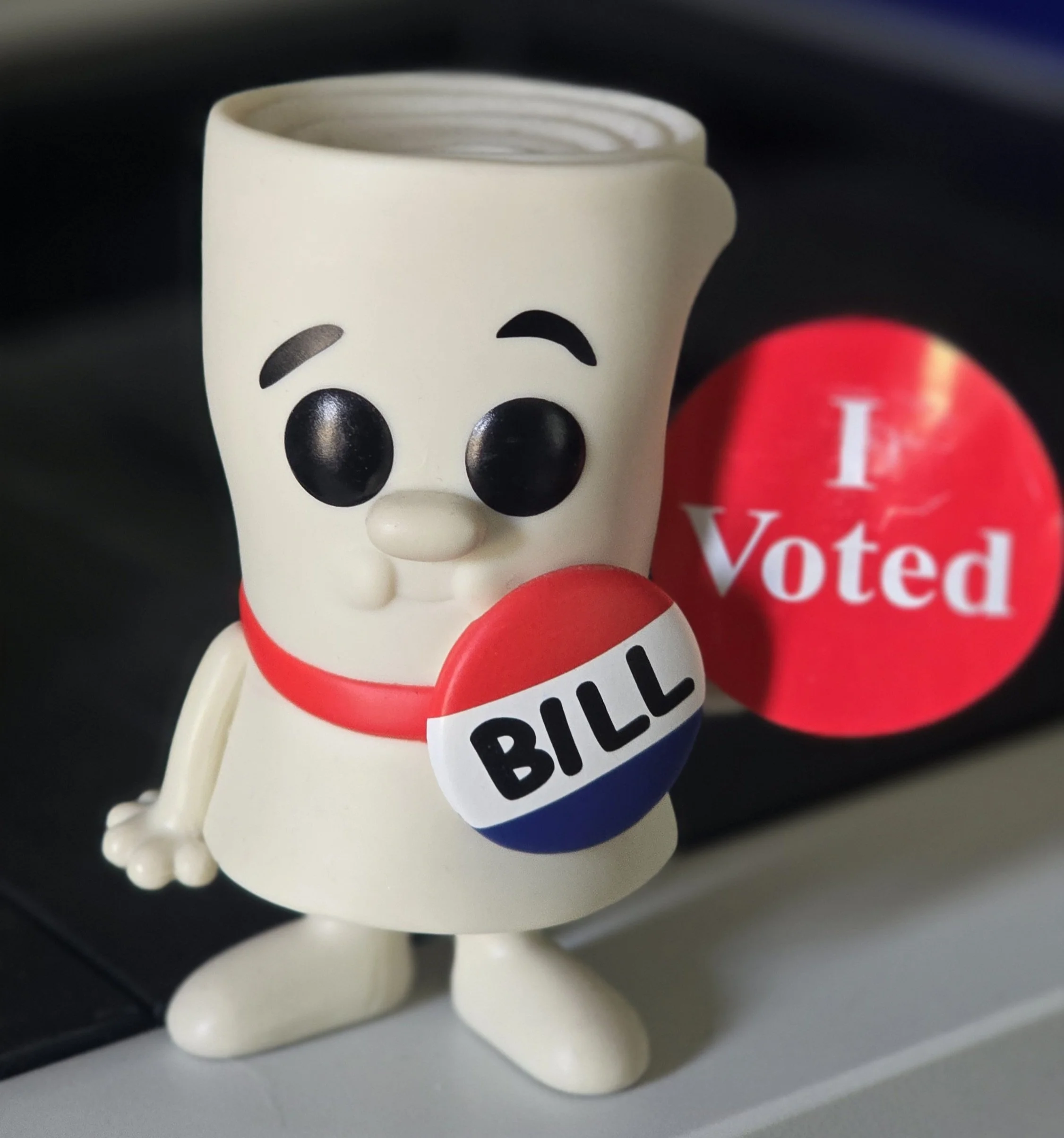 A figure of Bill from School House Rock holding a red Minnesota "I Voted" sticker