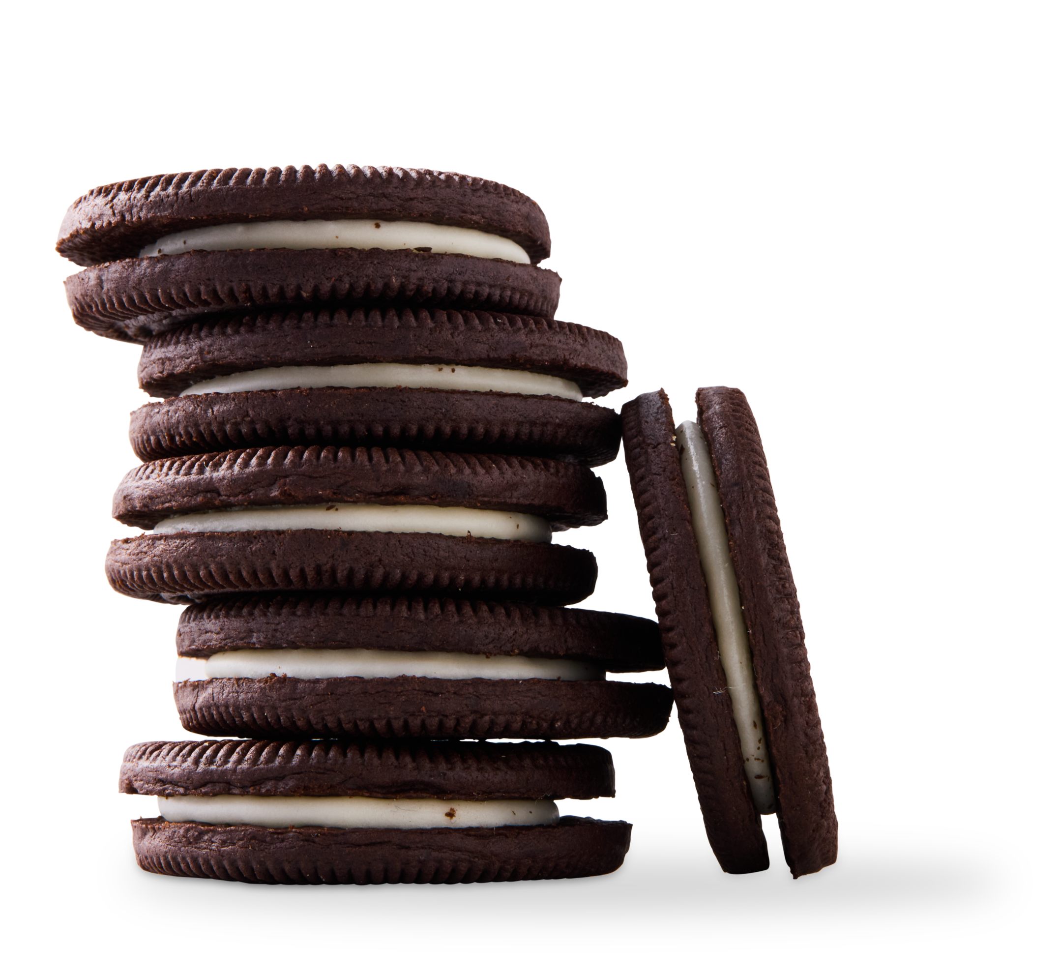 Stack of chocolate sandwich cookies with white cream filling, one cookie leaning against the stack.