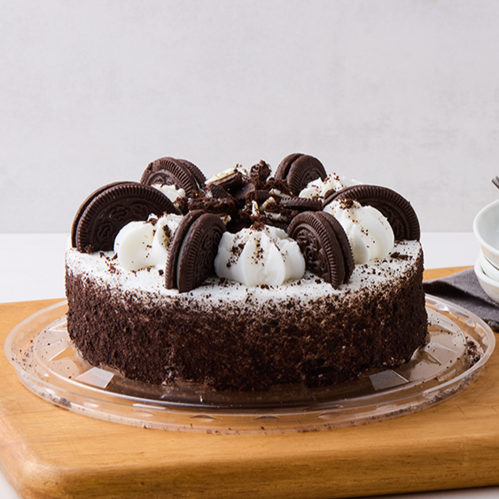 Chocolate Oreo cake decorated with Oreo cookies and whipped cream