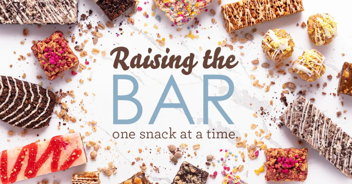 Various decorated snack bars and small treats surrounding the text 'Raising the BAR, one snack at a time' on a white background.