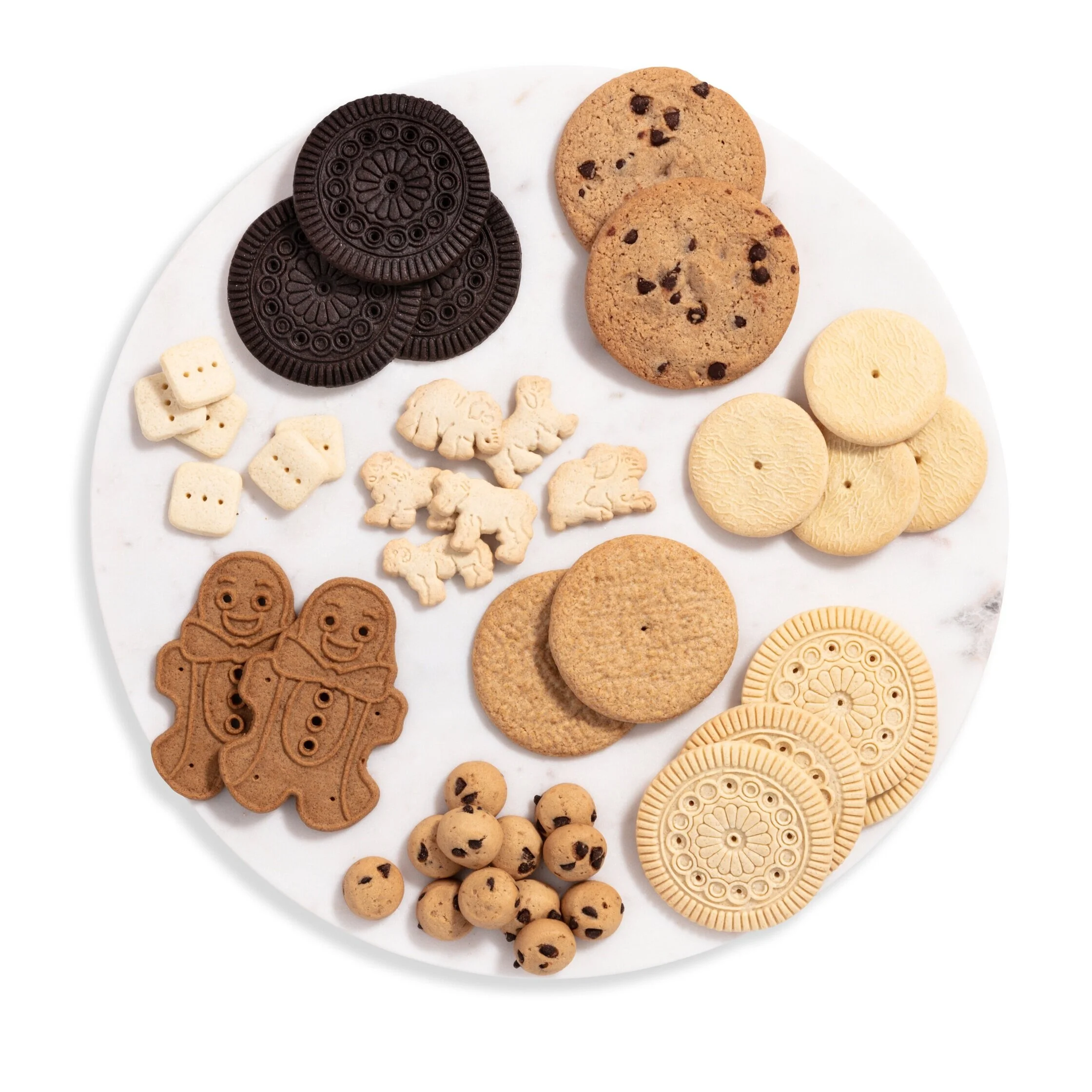 Assorted cookies on a white plate including chocolate sandwich cookies, chocolate chip cookies, gingerbread men, wafer rounds, and cookie balls.