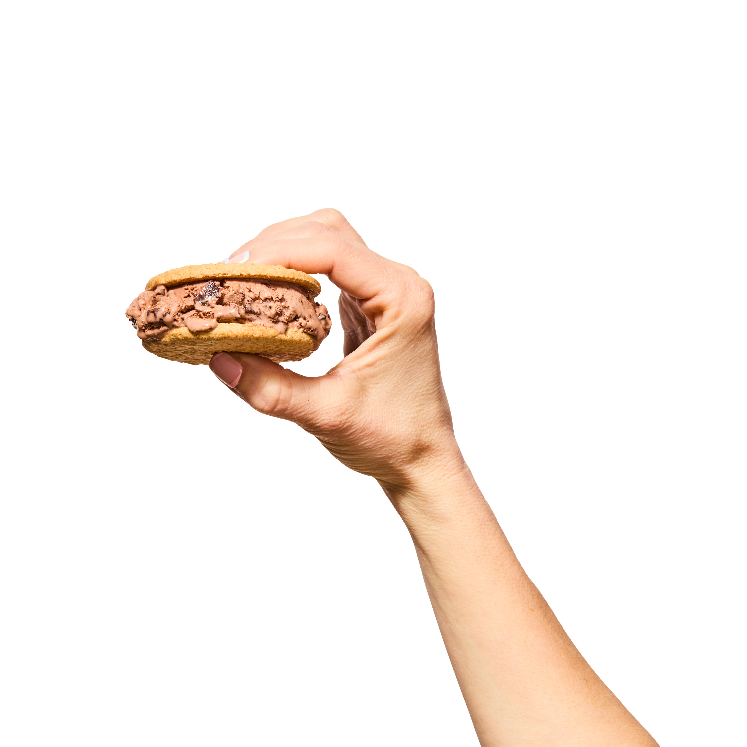 A hand holding a chocolate ice cream sandwich with vanilla cookies and chocolate ice cream, against a black background.
