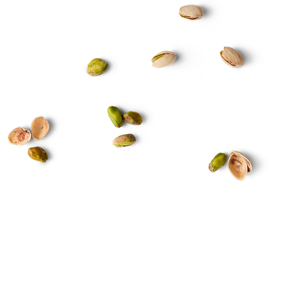 Pistachio nuts in shell and some without shells falling against a black background.