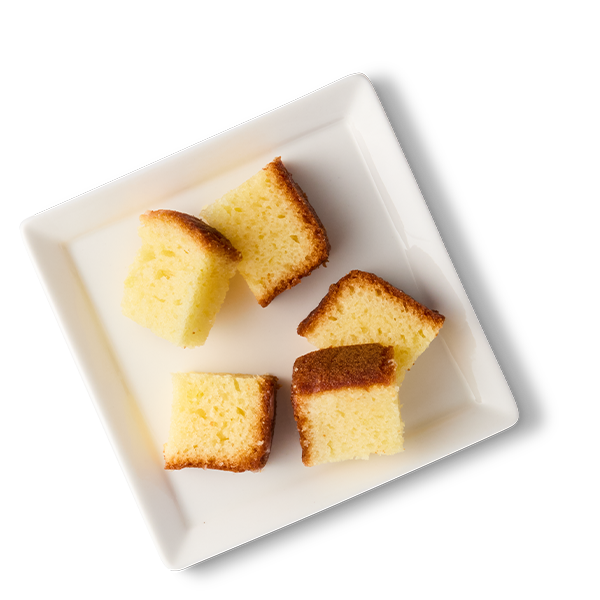 Six small pieces of cake on a white square plate.