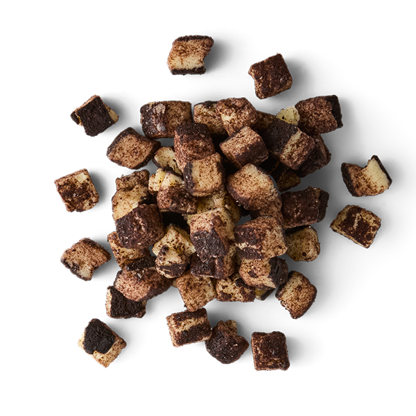 Frozen diced strawberries with chocolate coating on a black background.