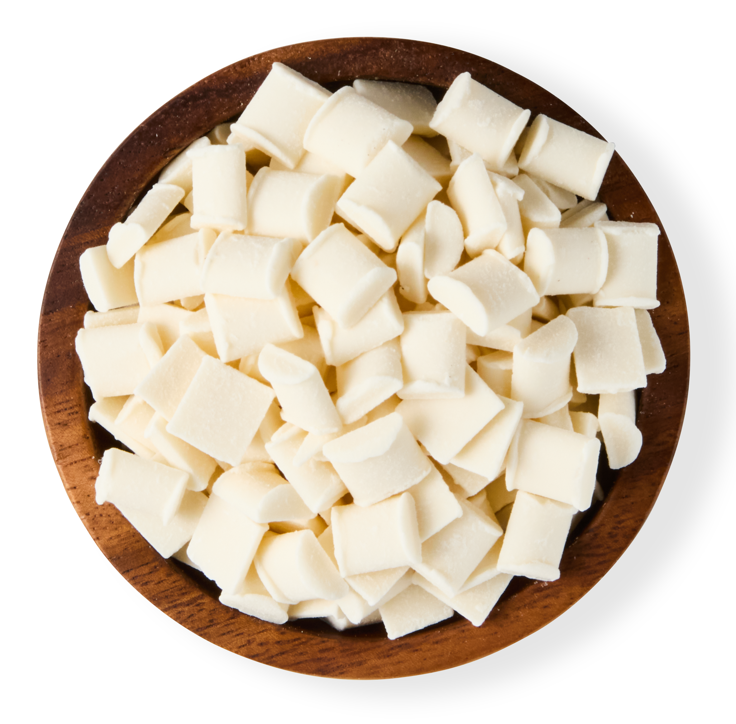 White chocolate chunks in a round wooden bowl.