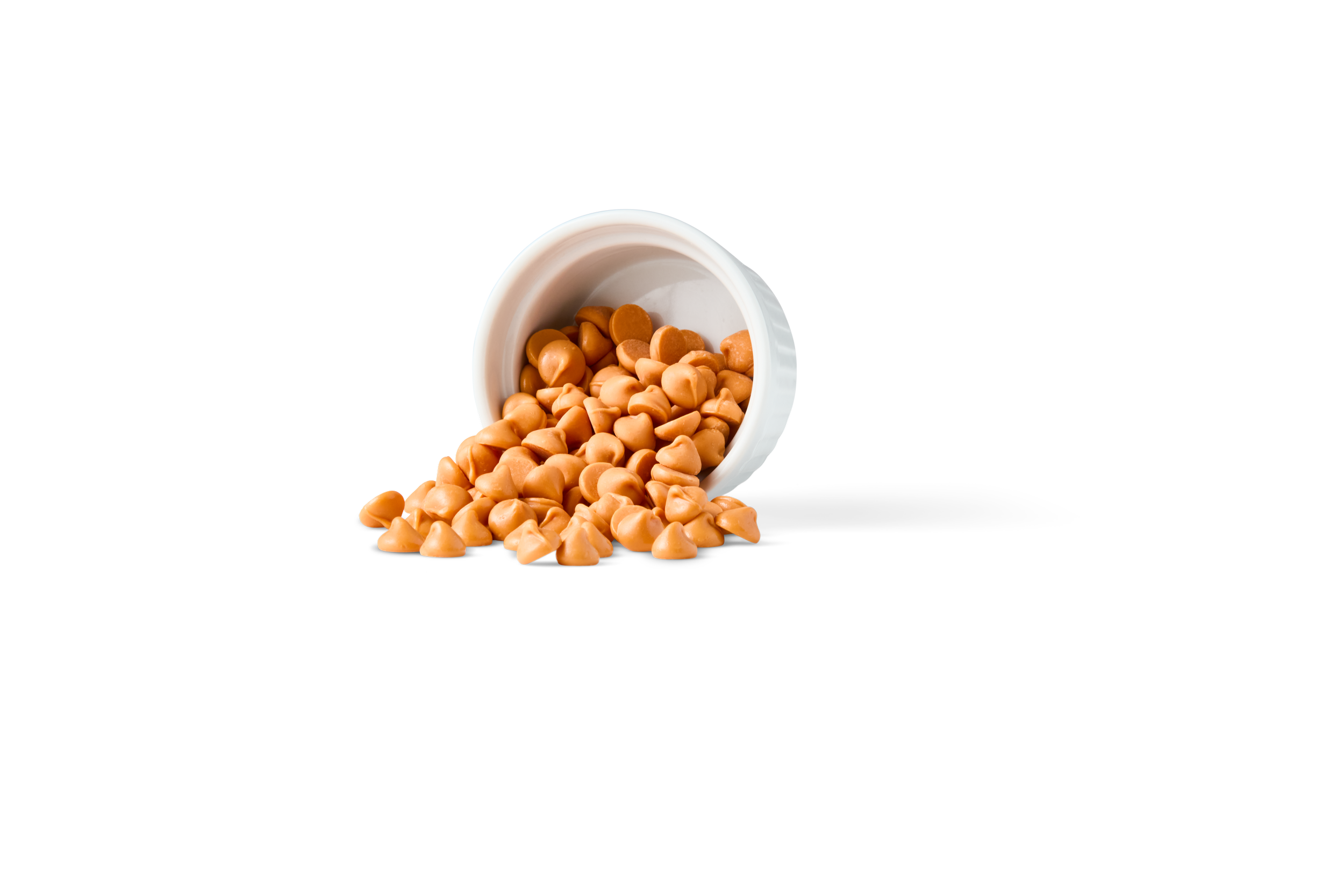 Caramel confectionery droplets spilling from a white dish, versatile inclusions for bakery, ice cream, dairy, and confectionery applications.
