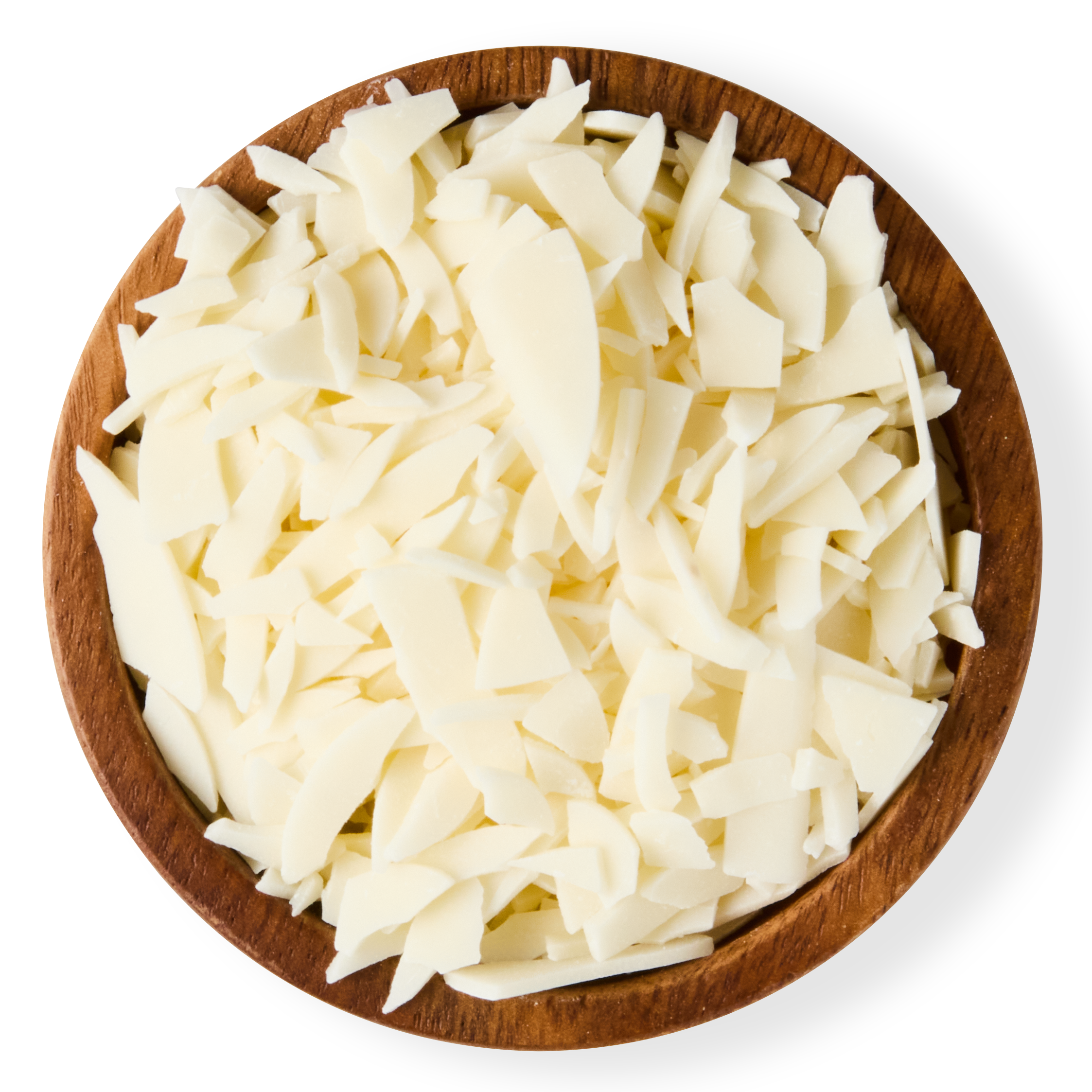 Shredded white chocolate flakes in a wooden bowl on a black background.