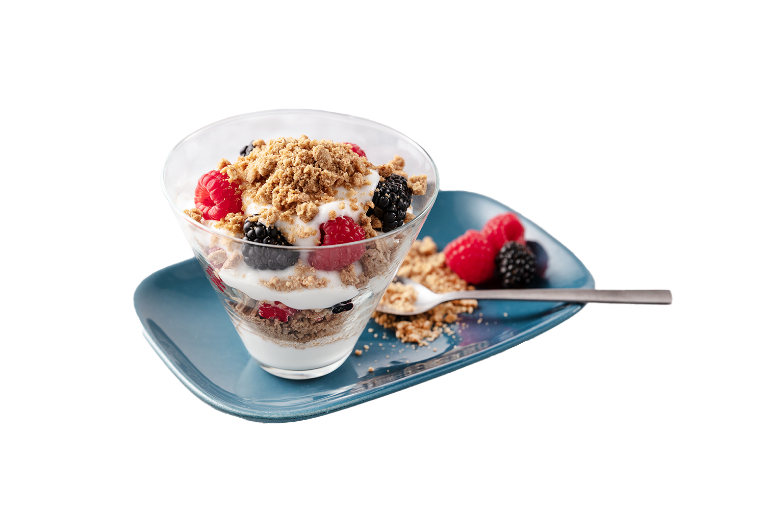 Berry parfait in a glass with crushed cookies and yogurt, served on a blue plate with a spoon and some extra crumbs and berries.