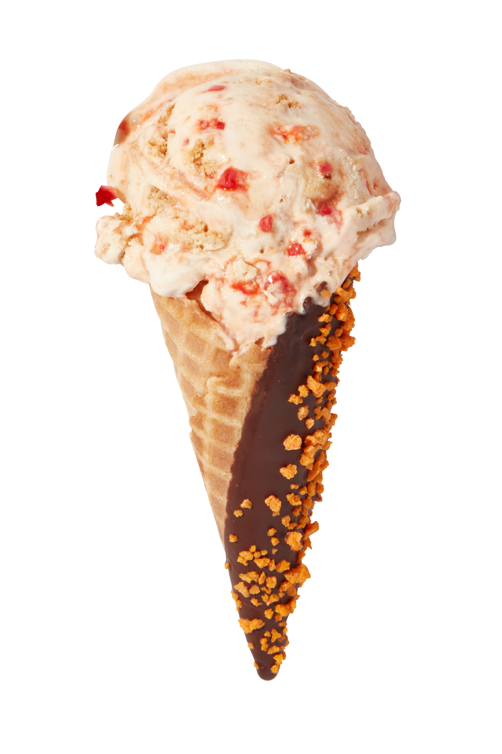 A scoop of strawberry ice cream with red fruit pieces in a waffle cone dipped in chocolate and sprinkled with crushed nuts.