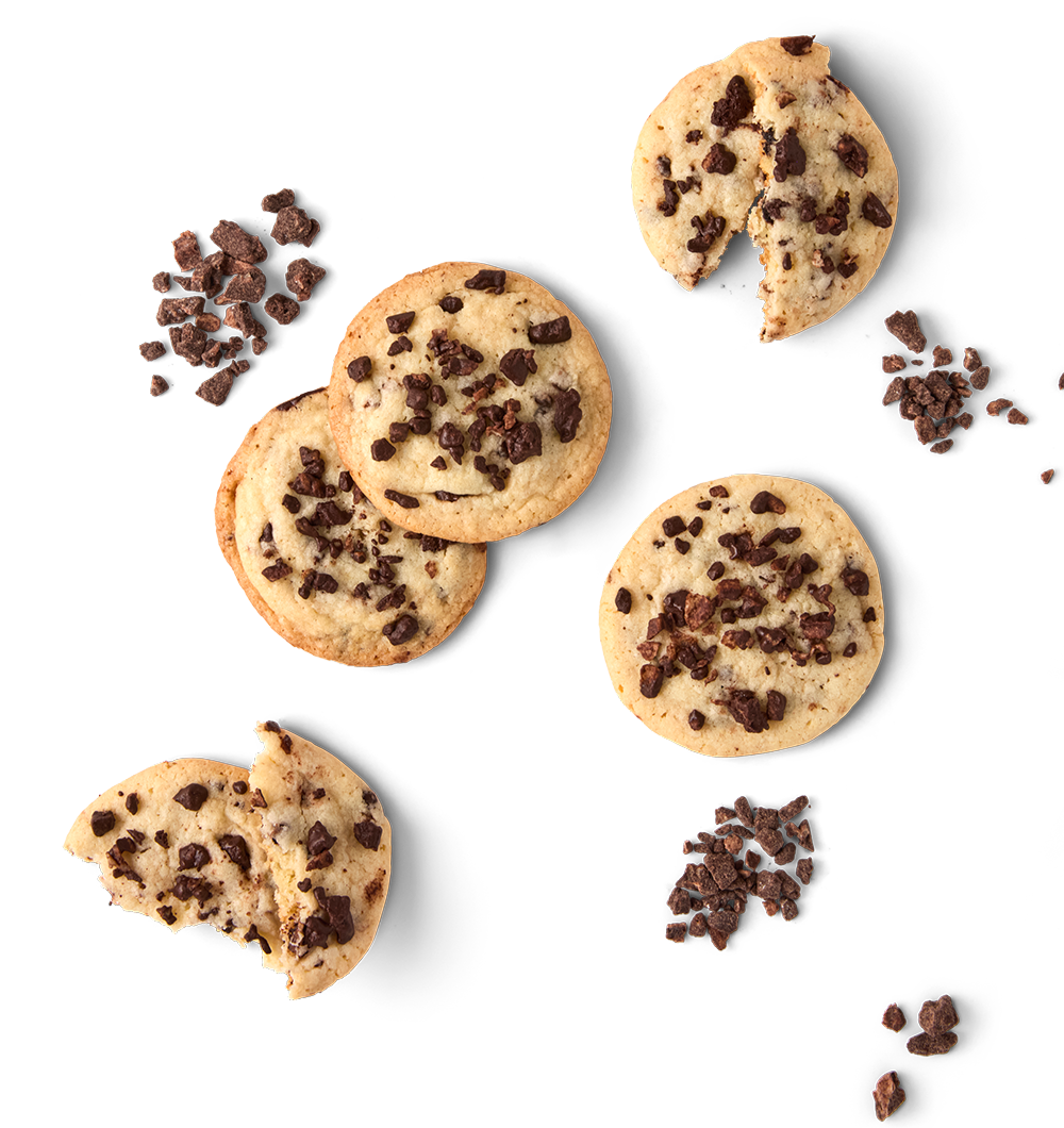 Chocolate chip cookies and scattered chocolate chunks on a black background.