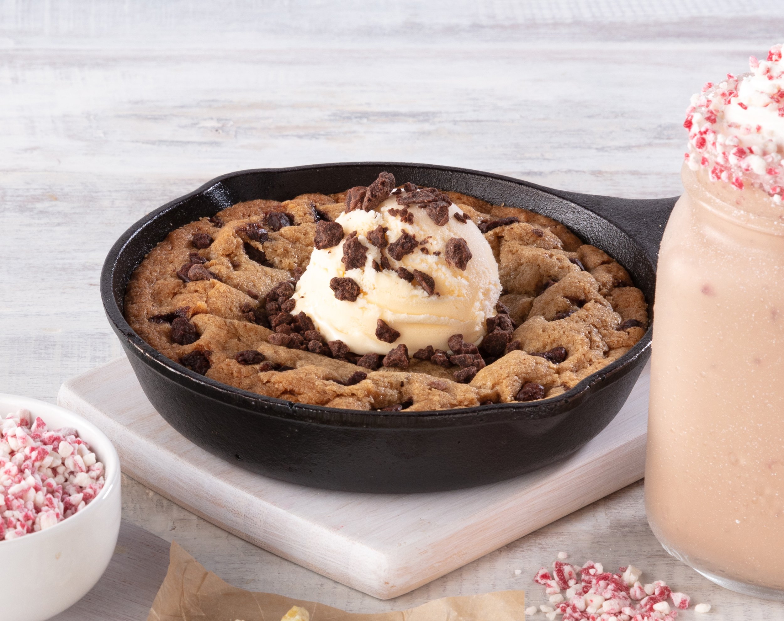 Chocolate chip cookie skillet with vanilla ice cream and chocolate shavings, peppermint hot chocolate with whipped cream and crushed peppermint
