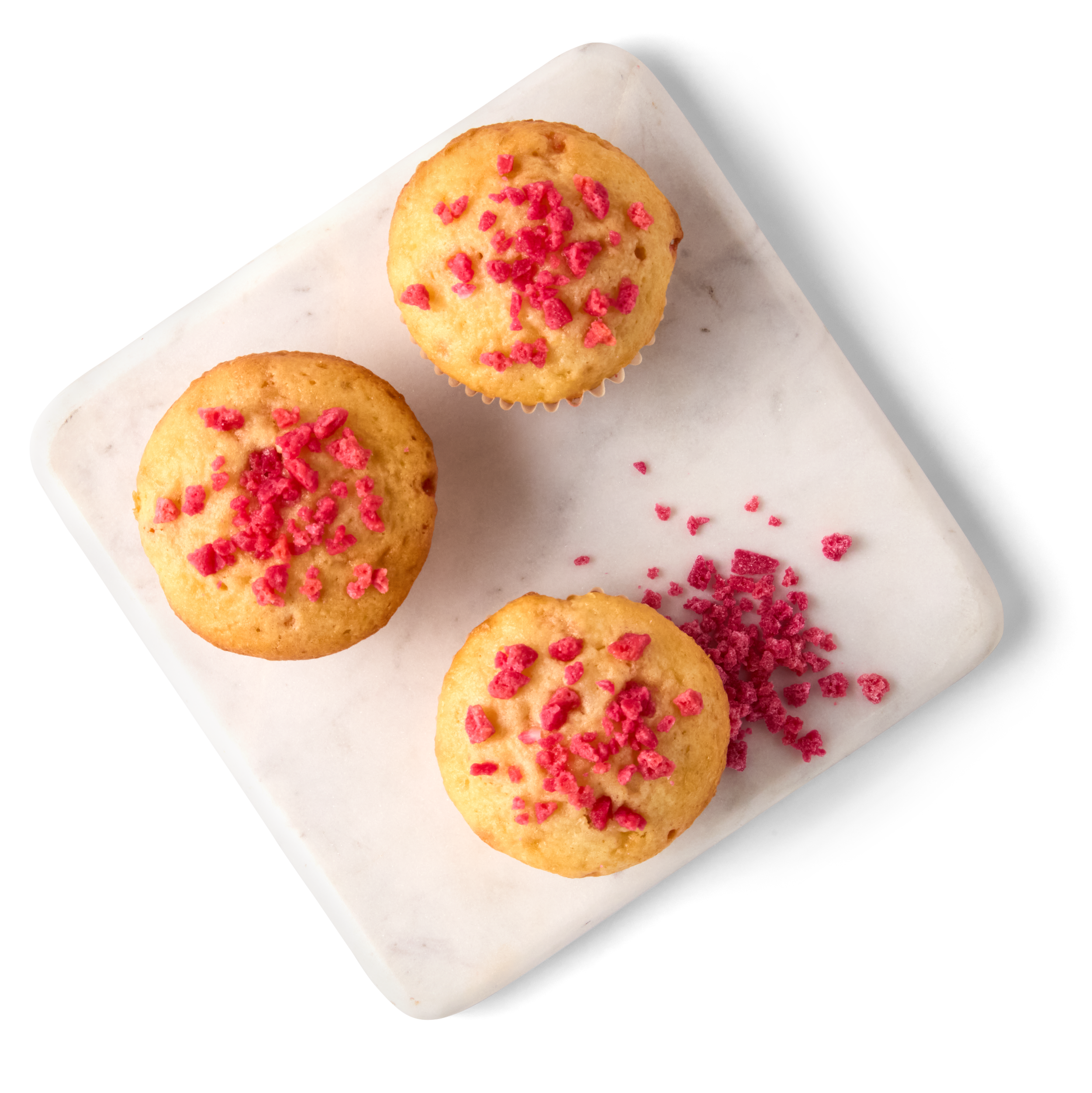 Three cupcakes with red crunchlets.