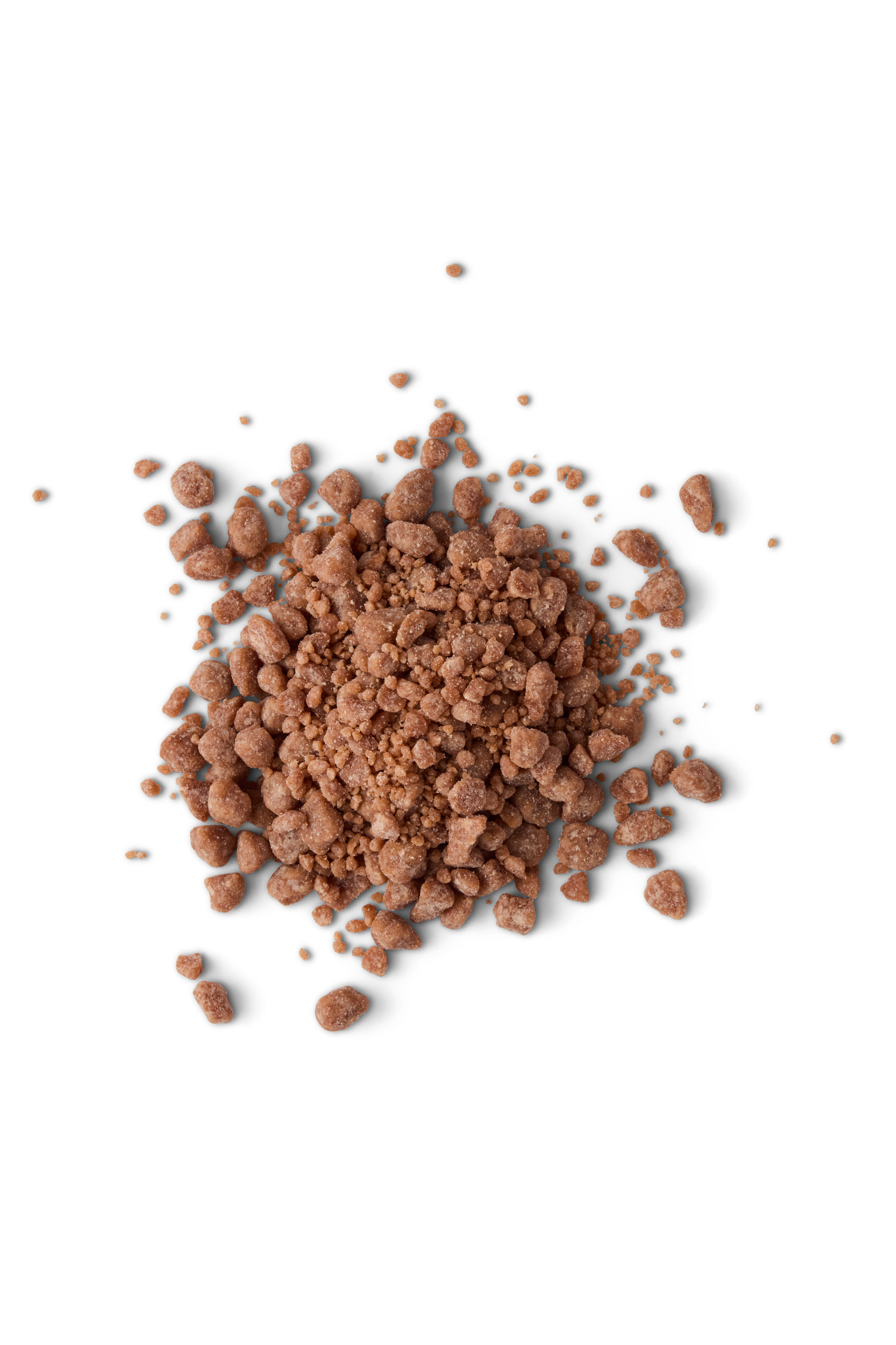 Granular brown substance, possibly salt or sand, scattered on a black background.