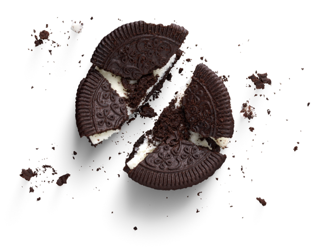 Broken chocolate and vanilla sandwich cookies with decorative embossed pattern and white filling, scattered crumbs, on a black background.