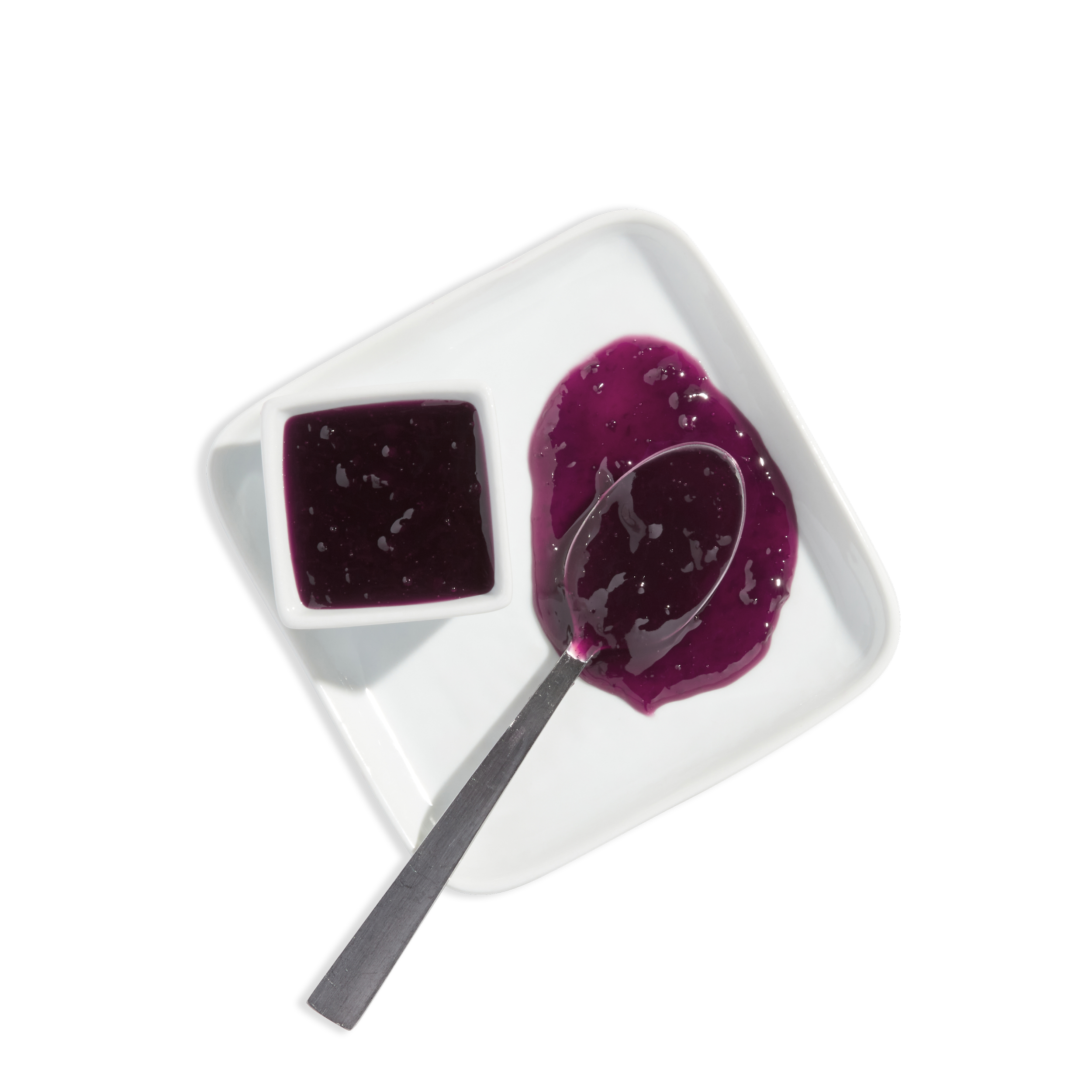 A white square dish holding purple jelly, with a spoon scooping some, atop a black background.
