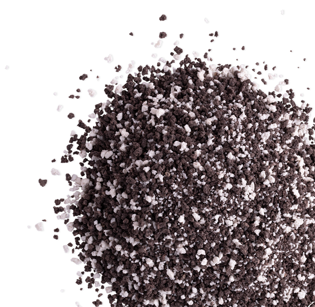 Close-up of a pile of black and white granulated salt on a black background