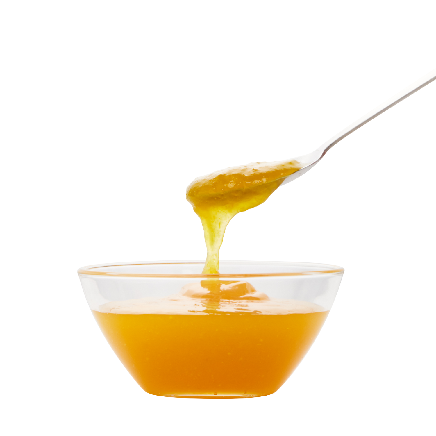 A spoon holding honey above a glass bowl filled with honey.