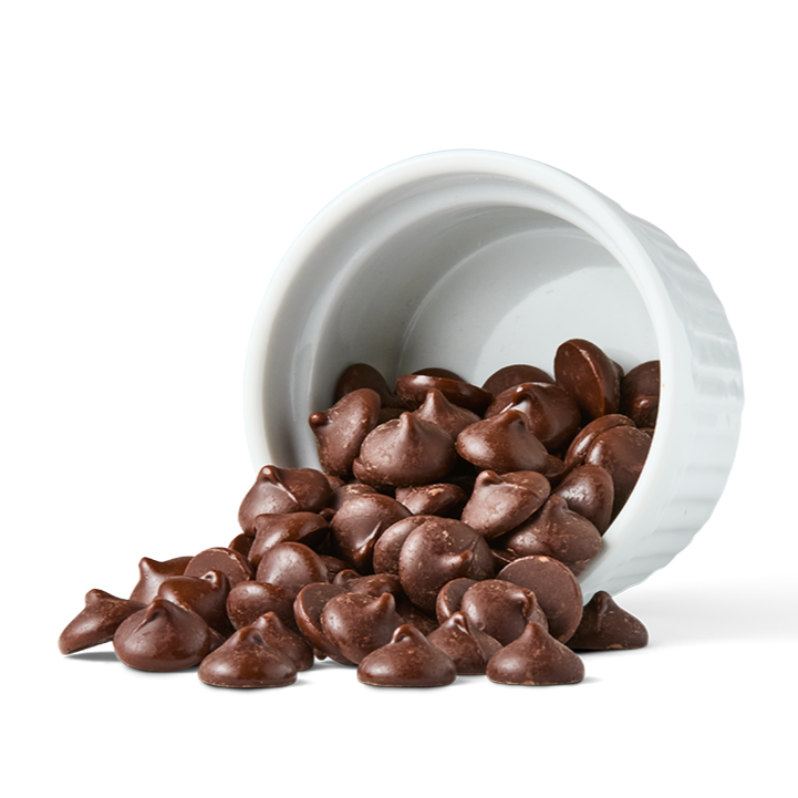 Chocolate chips spilled out of a white container.