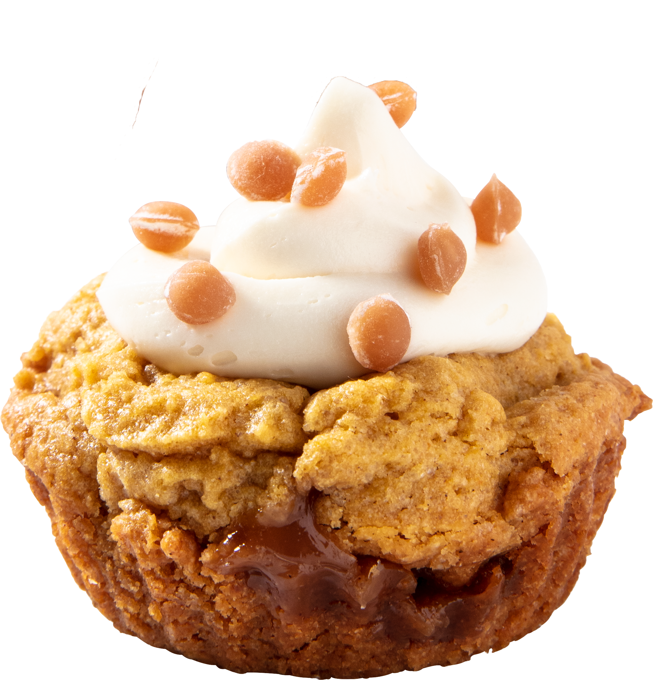 A close-up of a caramel apple cupcake topped with white frosting and caramel chips.