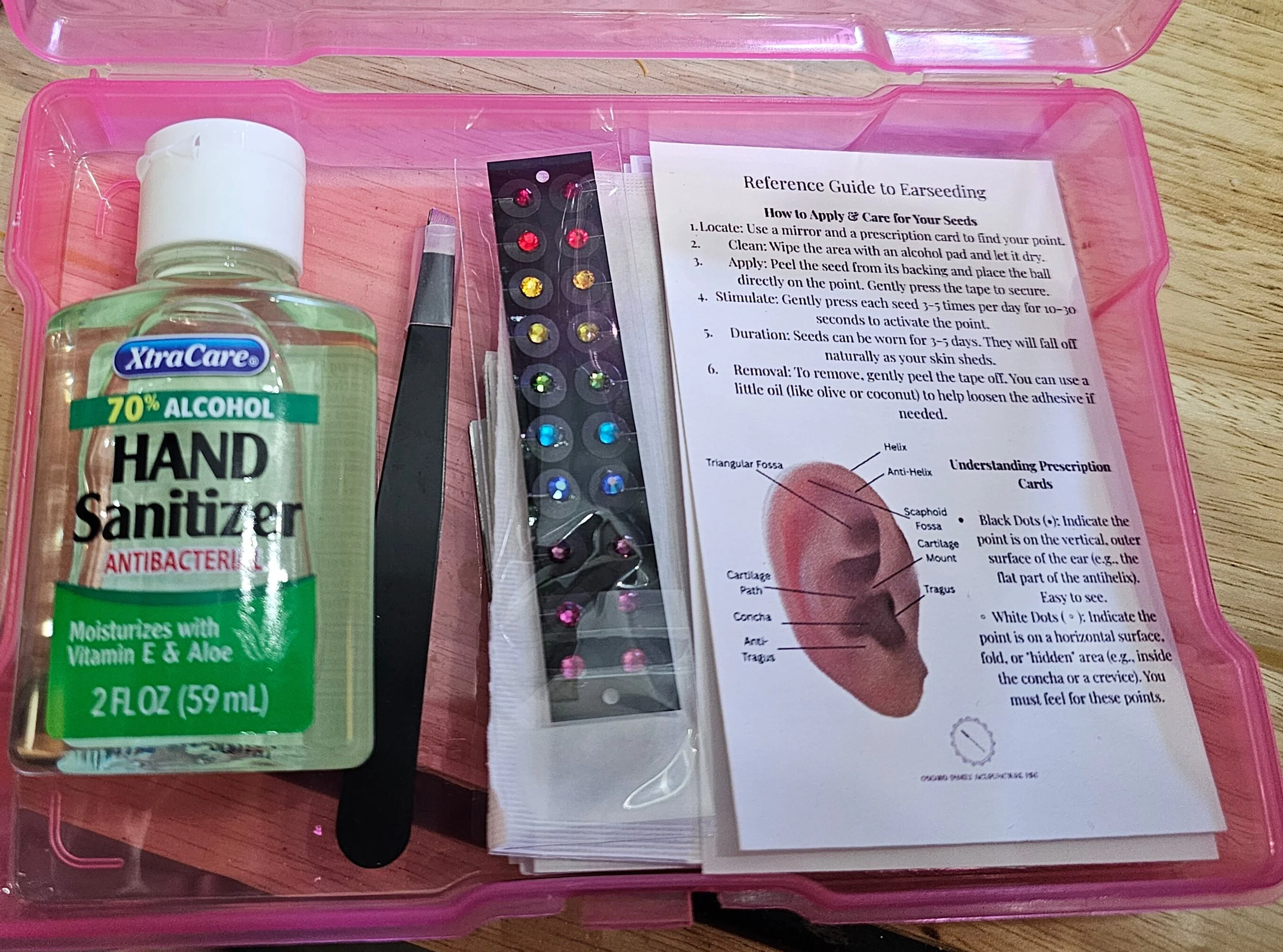 Earseeding kit including rainbow crystal earseeds, hand sanitizer, tweezers, instruction cards and alcohol swabs
