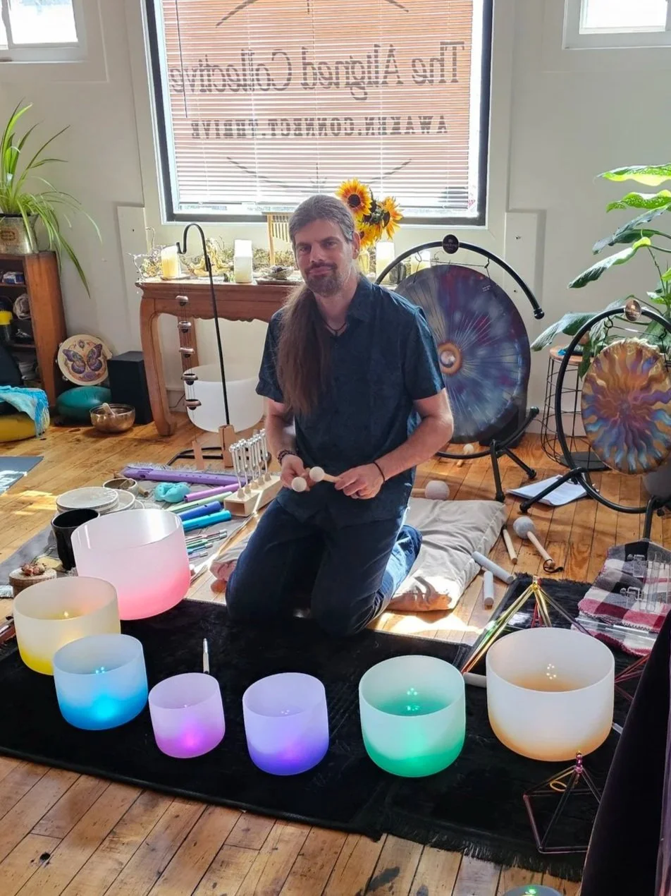 People laying on yoga mats in rows during a sound bath with acupuncture