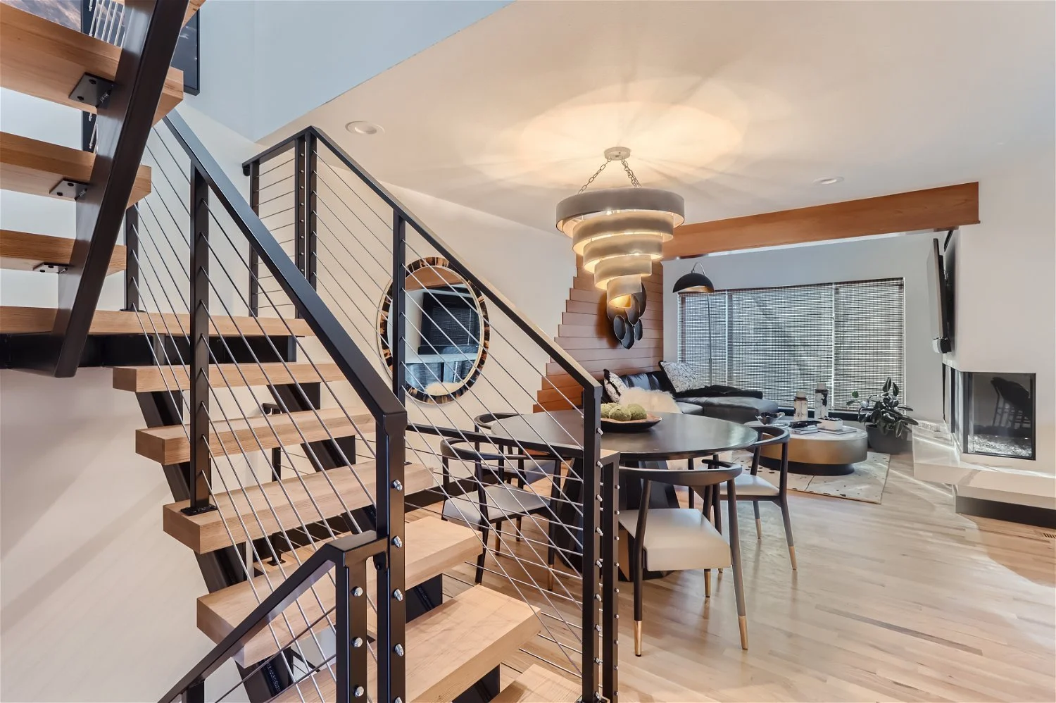 Alternate view of modern mountain Nordic living room through floating staircase
