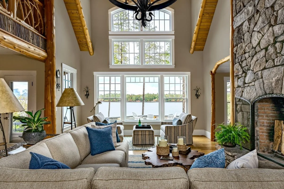 Lodge great room and L shaped couch with views of large window array