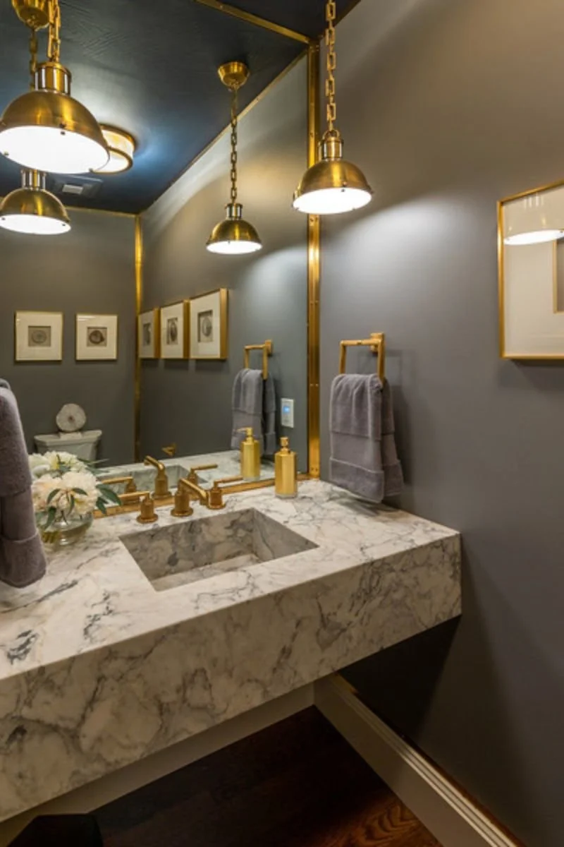 A floating marble vanity with an integrated ramp basin carved from a single slab for a seamless, sculptural effect.