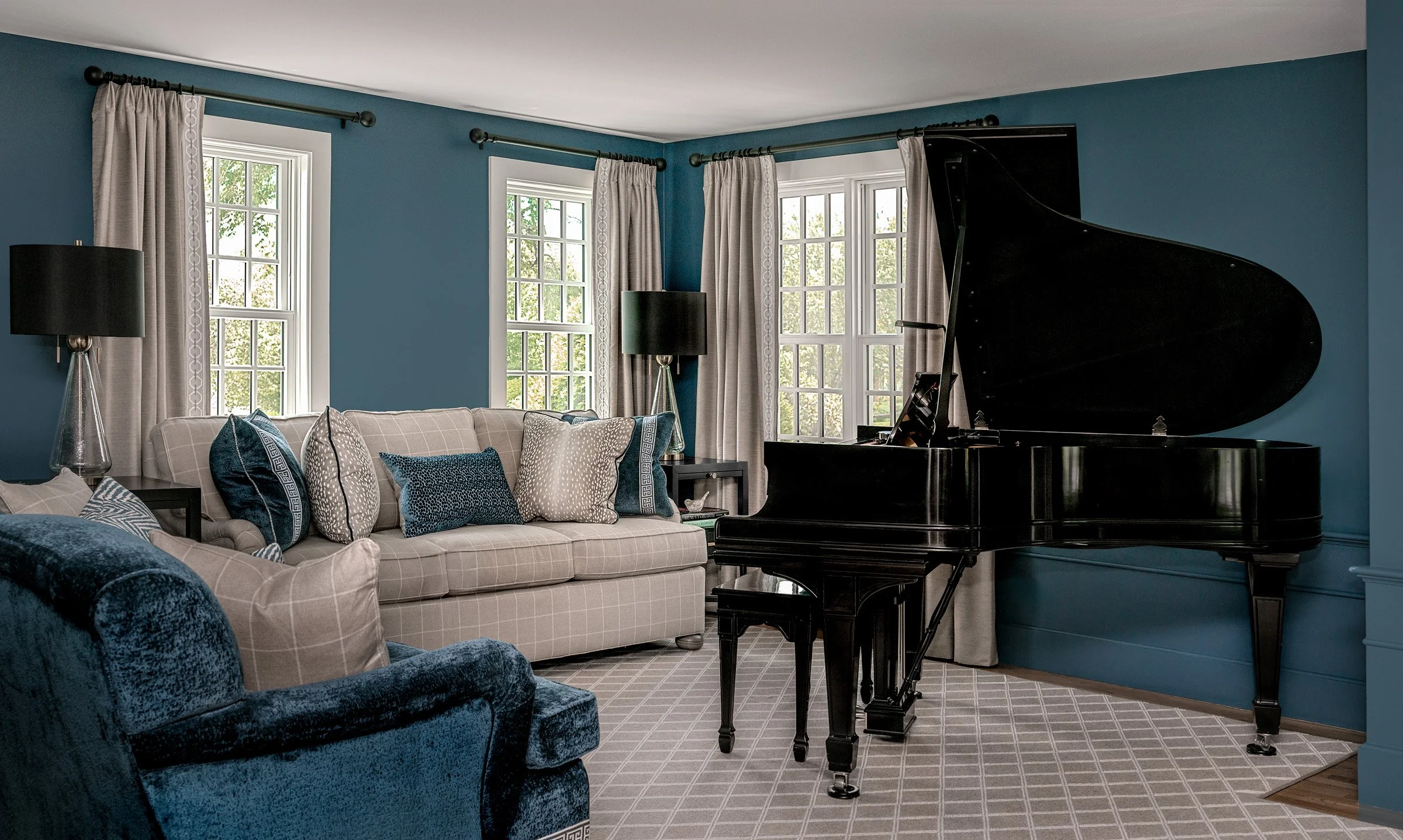 The grand piano is the centerpiece of this NH living room.