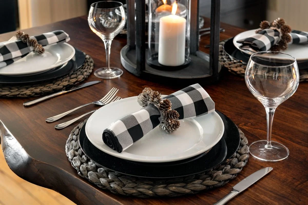 Close up of black and white table setting on live edge dining table