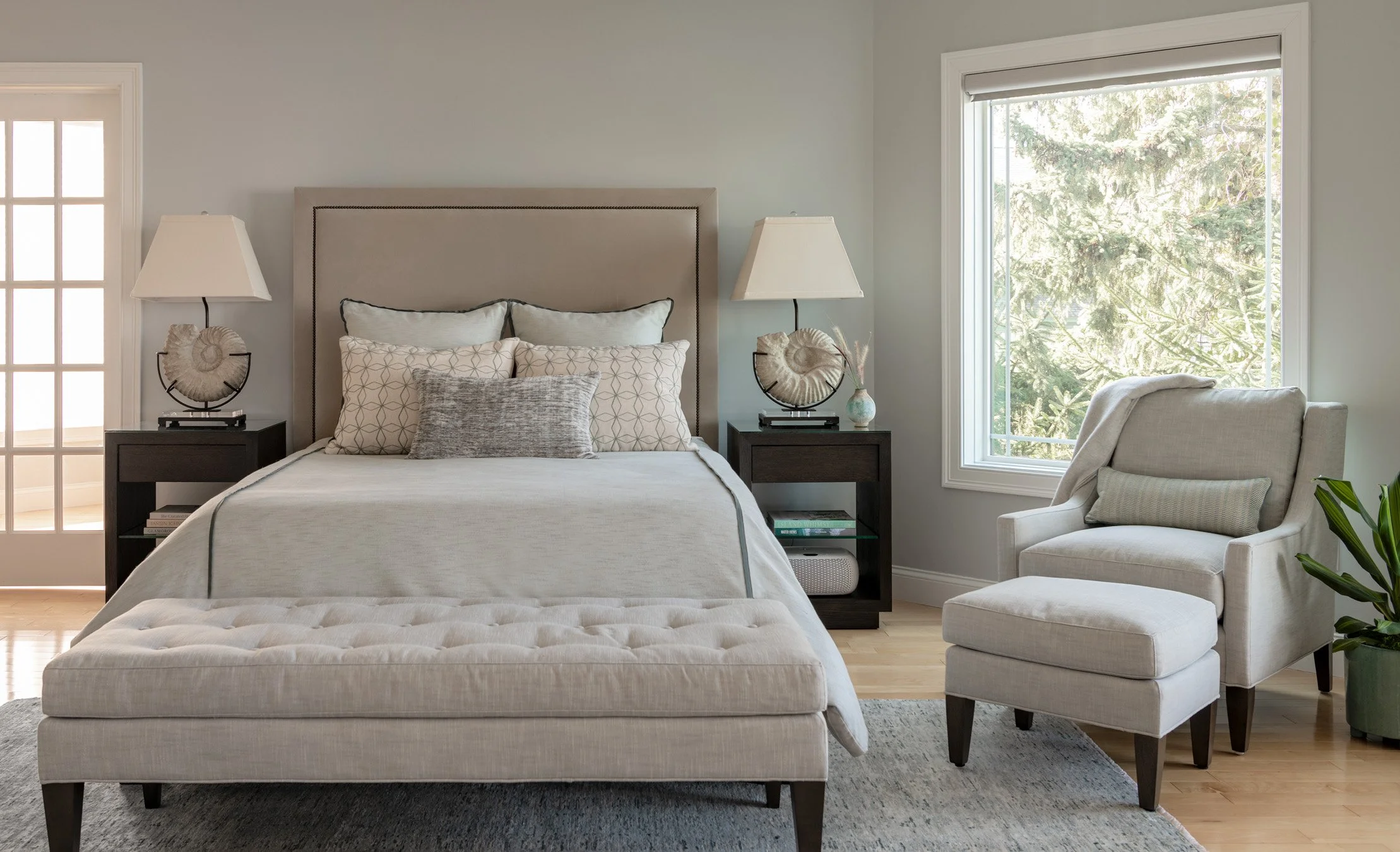 Neutral coastal themed bedroom with seating area