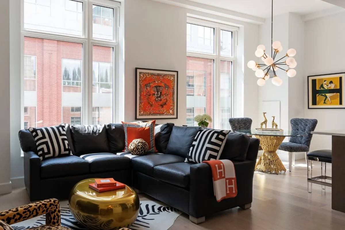 Boston warf condo living room with black sofa and view of dining nook