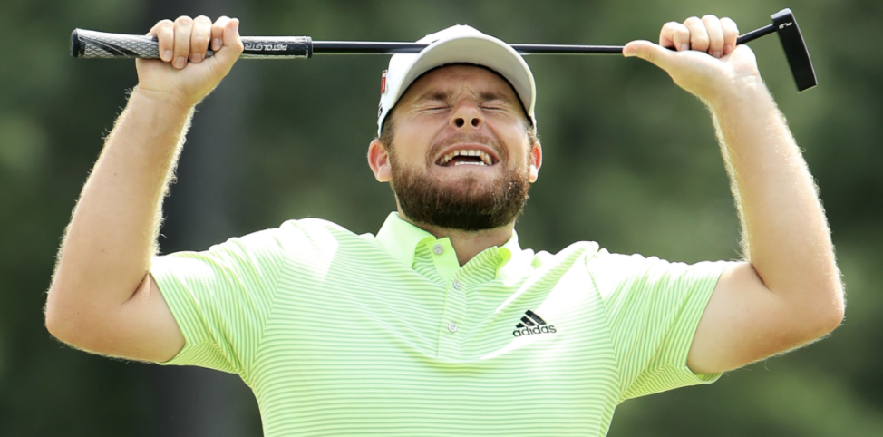 Golfer showing negative body language after missing putt, demonstrating impact of negative self-talk.