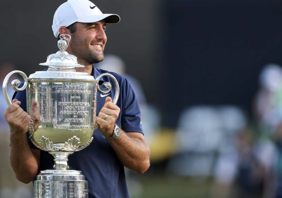 Golfer smiling as they hold up the trophy from the golf tournament they won.