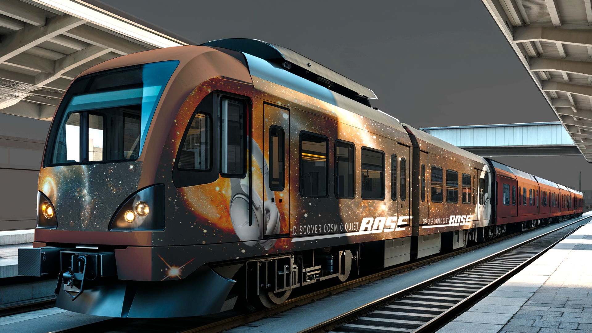 A modern train decorated with a cosmic space-themed design featuring stars and galaxies, stopped at a station platform.