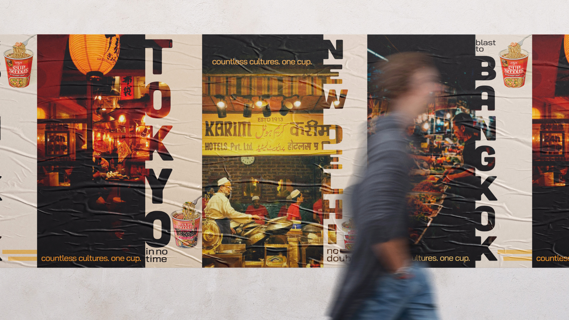 A person walking past a colorful urban mural with images of Asian food, lanterns, and street scenes, promoting diverse cultures and cuisines.