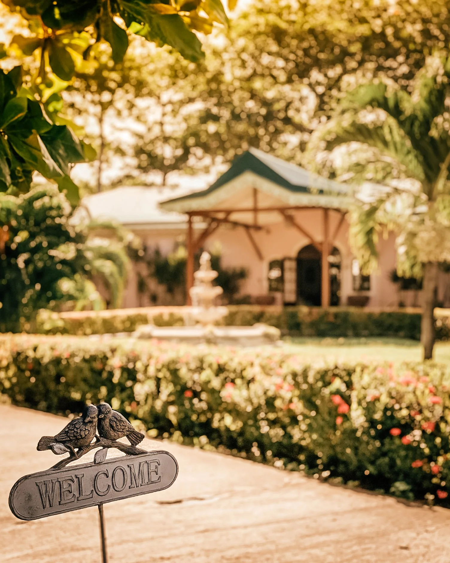 welcome sign infront of reception and gardens