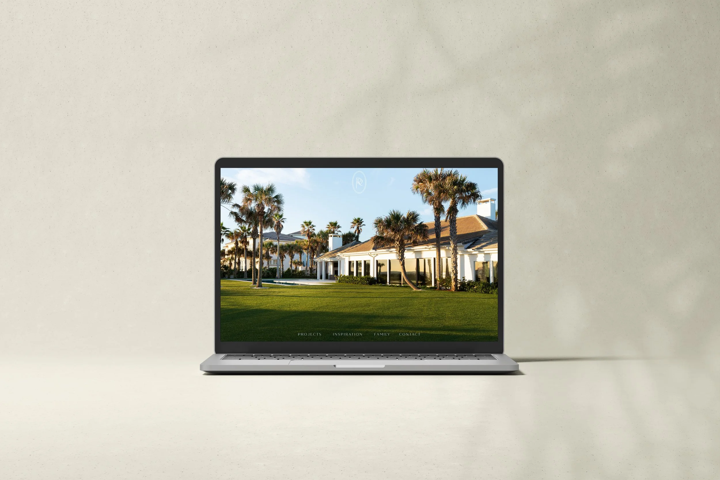 Laptop computer on a plain surface showing a webpage with a scenic image of palm trees, a house, and a blue sky.