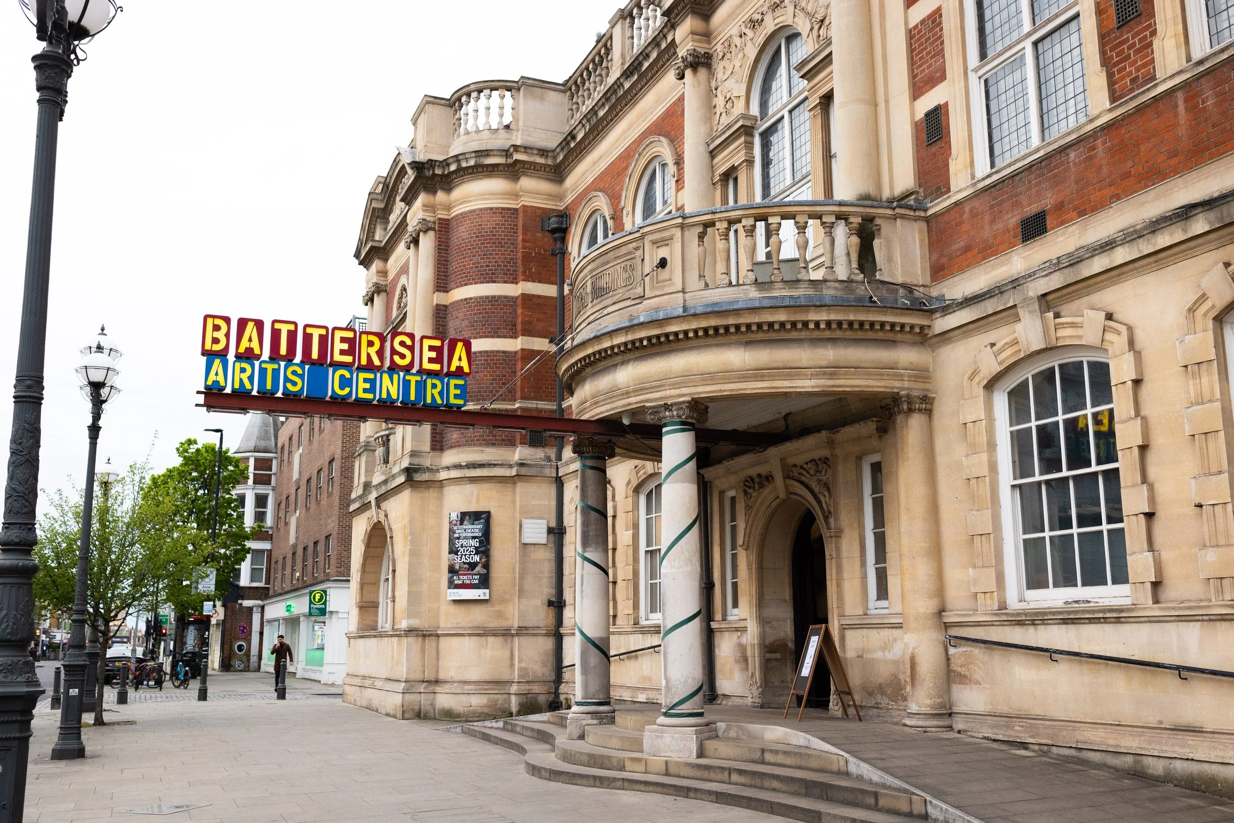 Exterior of the Battersea Arts Centre building with a colorful sign and decorative architecture.
