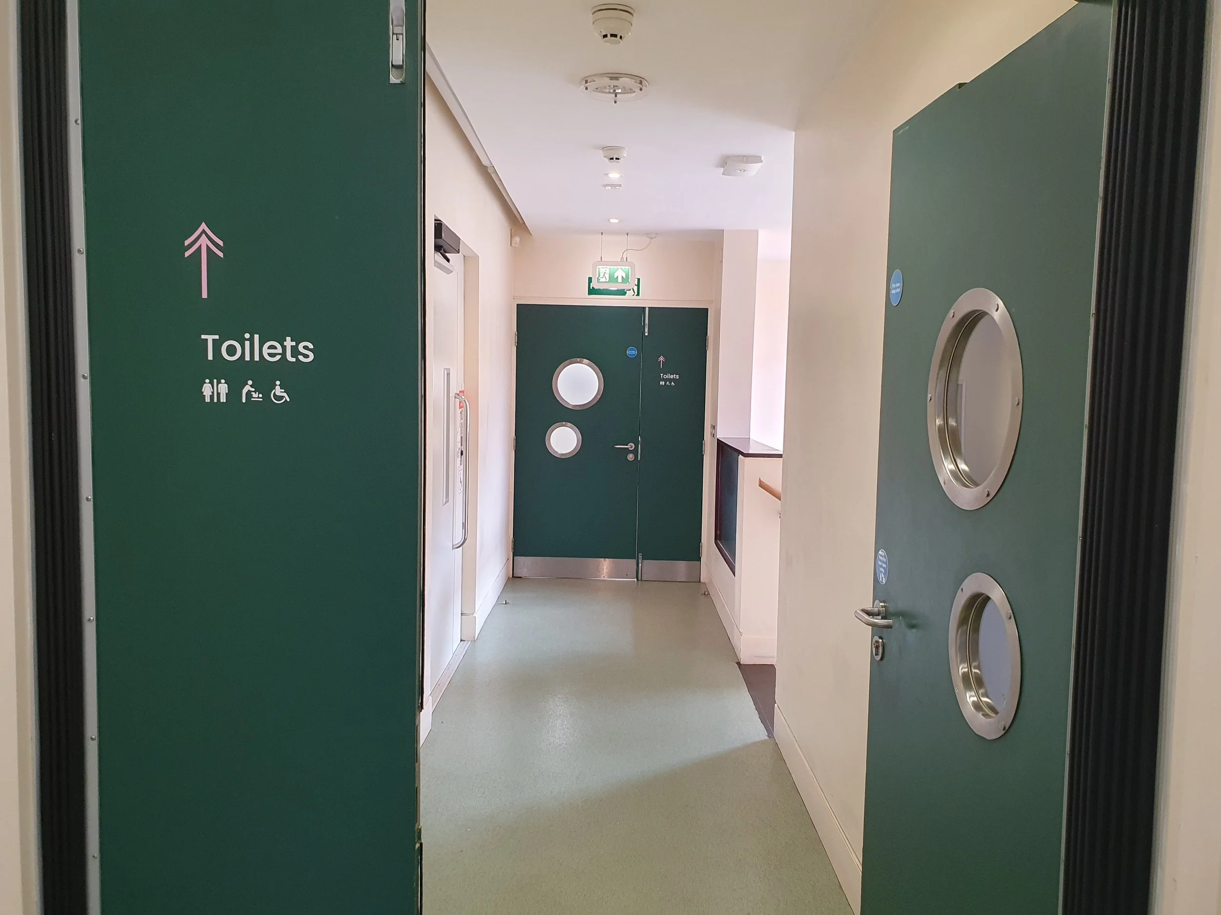 To get to the toilets, go through both sets of doors, straight ahead.