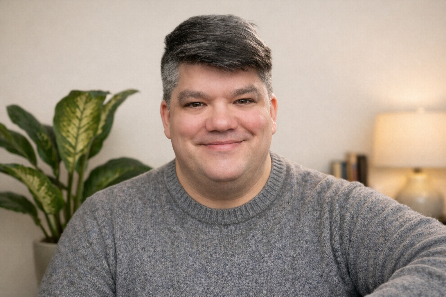 Daniel Hayes, licensed therapist, smiling in a professional office setting.
